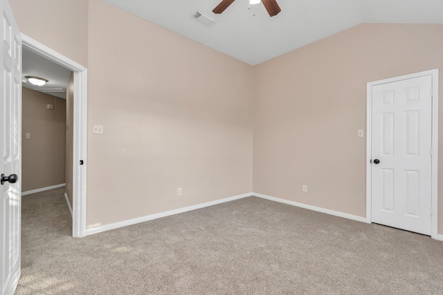 empty room featuring light colored carpet, vaulted ceiling, and ceiling fan