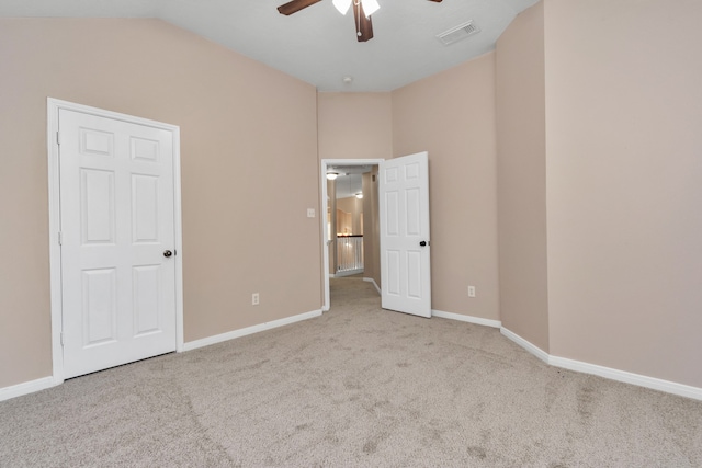 carpeted spare room with ceiling fan and lofted ceiling