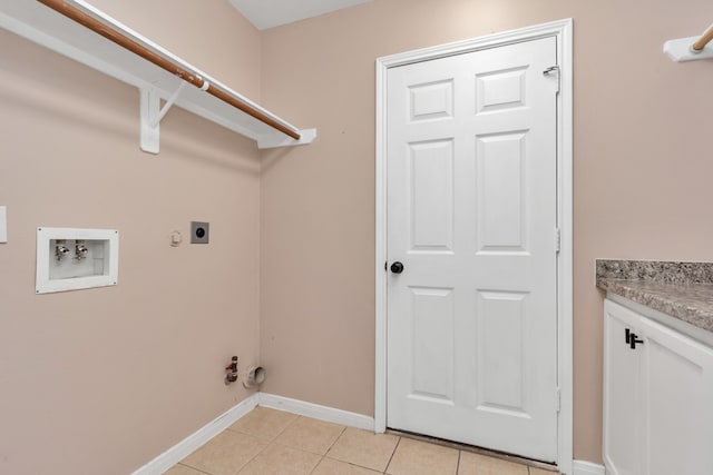 clothes washing area featuring light tile flooring, hookup for a gas dryer, electric dryer hookup, and hookup for a washing machine