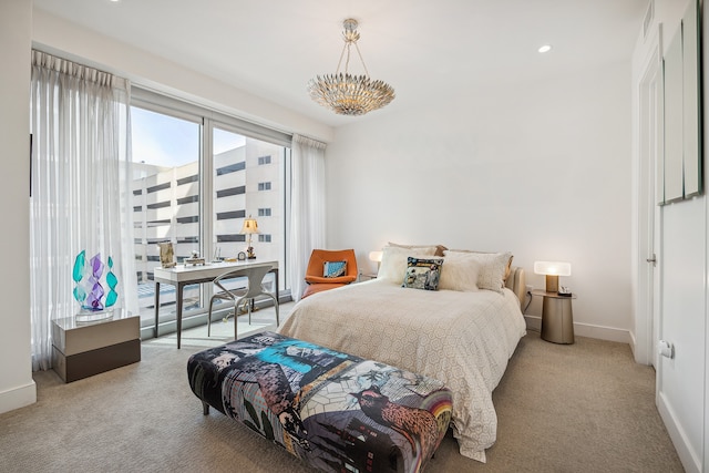 carpeted bedroom featuring a notable chandelier