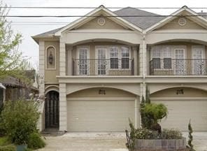 view of front of house with a garage and a balcony