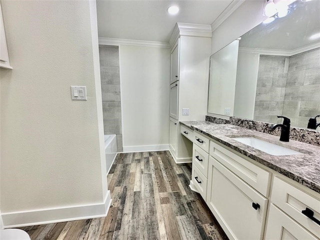 bathroom with ornamental molding, vanity, and hardwood / wood-style flooring