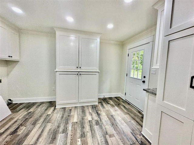 interior space featuring wood-type flooring and ornamental molding