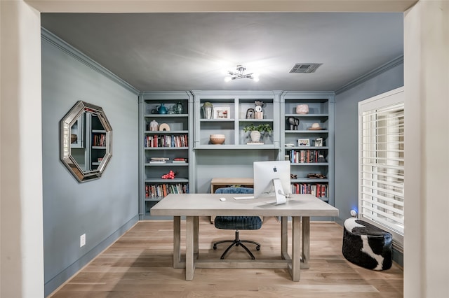 home office with ornamental molding and light wood-type flooring