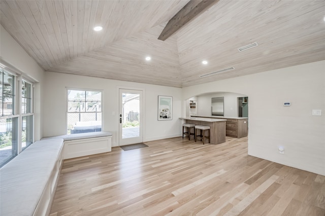 unfurnished living room featuring light hardwood / wood-style flooring and wood ceiling