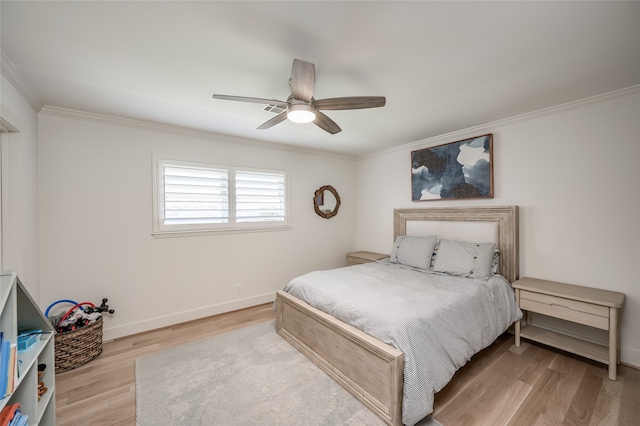 bedroom featuring ceiling fan, crown molding, and light hardwood / wood-style floors