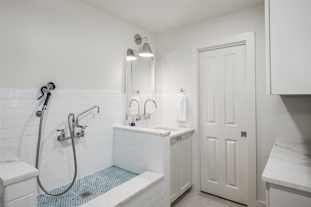 bathroom with a tile shower and tile flooring