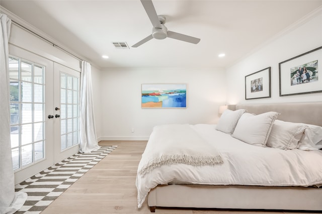 bedroom with light wood-type flooring, access to exterior, multiple windows, and french doors