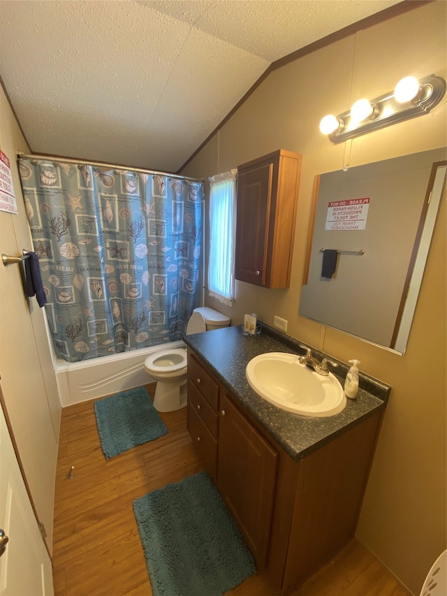 full bathroom featuring vanity, toilet, vaulted ceiling, shower / bath combination with curtain, and hardwood / wood-style flooring