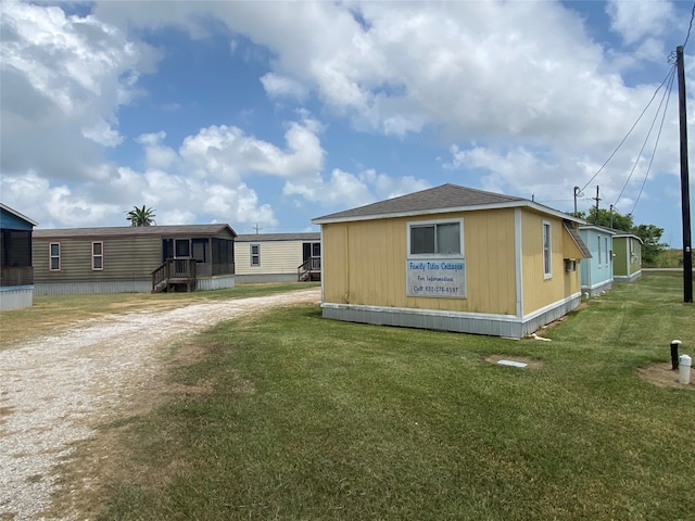 view of side of home featuring a yard