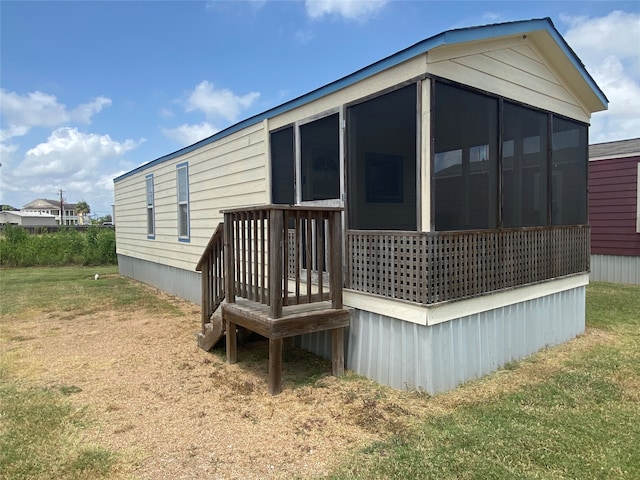 view of side of home featuring a lawn