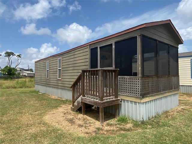 view of side of home with a yard