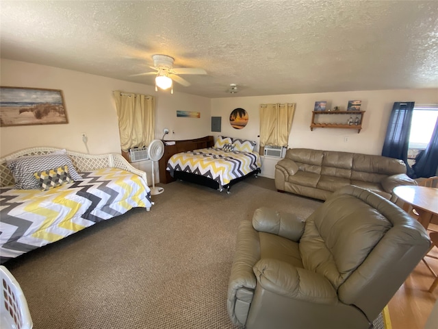 carpeted bedroom featuring a textured ceiling and ceiling fan