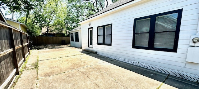 view of side of property with a patio area