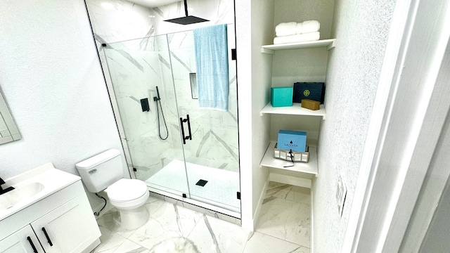 bathroom featuring a shower with door, tile flooring, vanity, and toilet