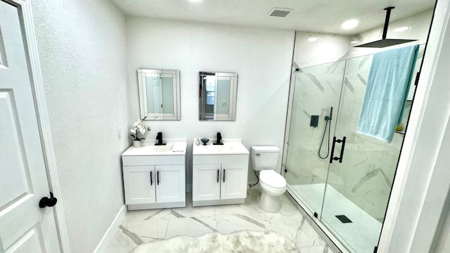 bathroom with double sink, vanity with extensive cabinet space, walk in shower, tile floors, and toilet