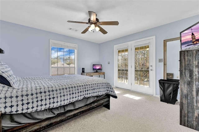 carpeted bedroom with ceiling fan, multiple windows, and access to outside