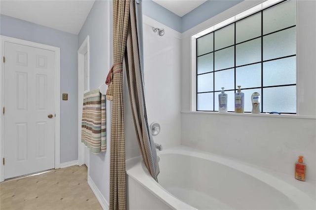 bathroom featuring shower / tub combo with curtain