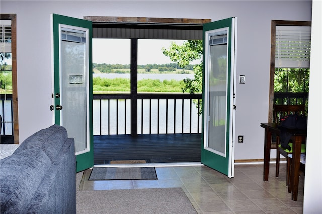 entryway featuring a water view and tile patterned flooring