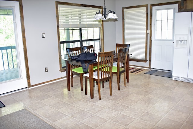 dining space featuring light tile patterned floors and a chandelier