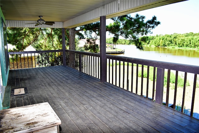 wooden deck with a water view and ceiling fan