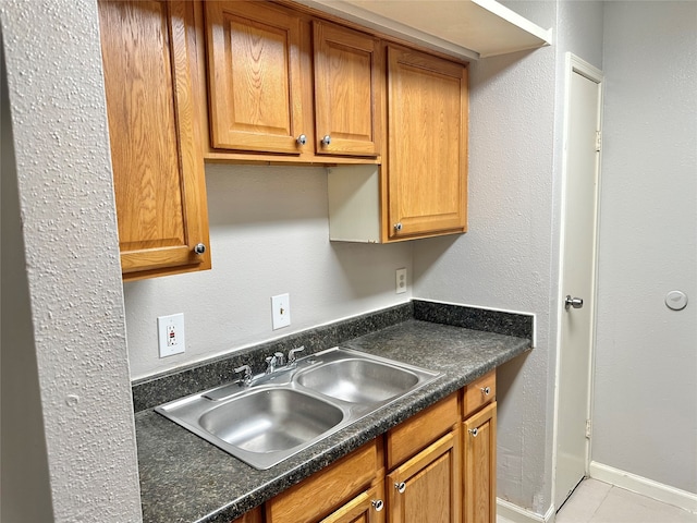 kitchen featuring light tile flooring and sink