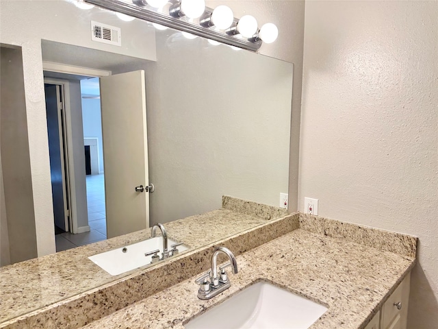 bathroom featuring tile flooring and vanity