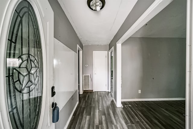 hallway with dark hardwood / wood-style flooring