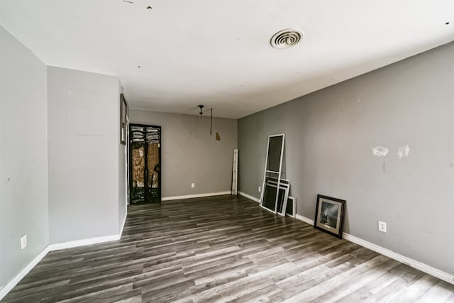 unfurnished room with dark hardwood / wood-style floors