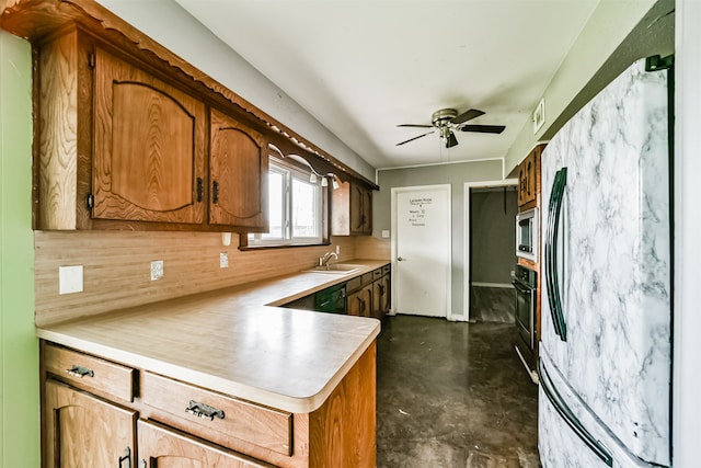 kitchen featuring oven, stainless steel microwave, ceiling fan, refrigerator, and tasteful backsplash