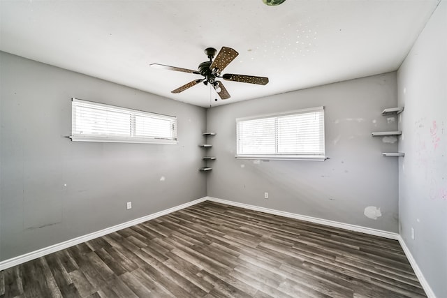 spare room featuring ceiling fan and dark hardwood / wood-style floors