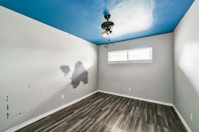 unfurnished room featuring ceiling fan and dark hardwood / wood-style floors