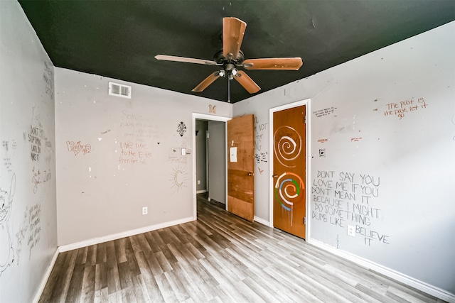 spare room featuring ceiling fan and hardwood / wood-style flooring