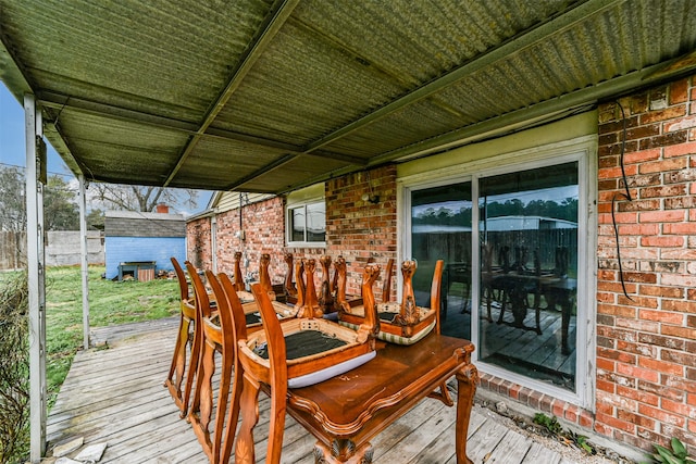 wooden deck featuring a storage unit