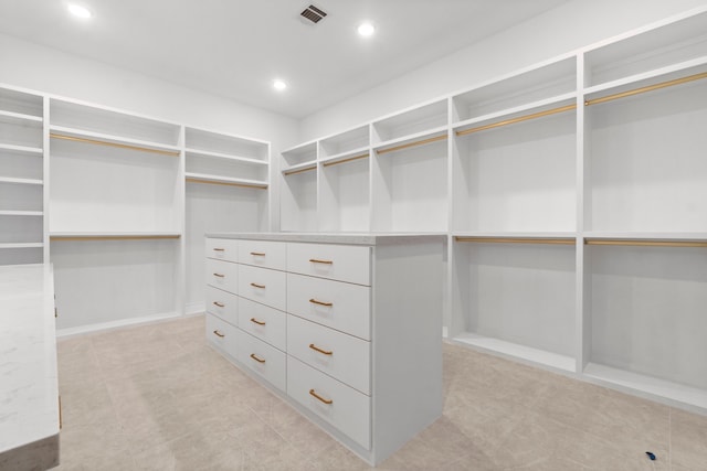 spacious closet with light tile floors