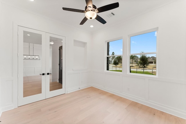 unfurnished bedroom featuring ceiling fan, light hardwood / wood-style floors, and french doors