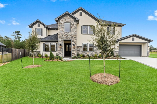 view of front of property featuring a garage and a front yard