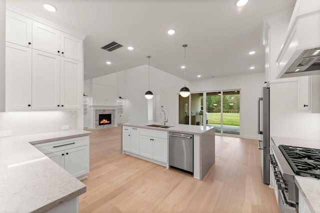 kitchen with white cabinetry, appliances with stainless steel finishes, sink, and pendant lighting