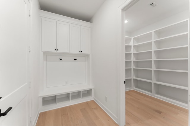 mudroom with light hardwood / wood-style floors