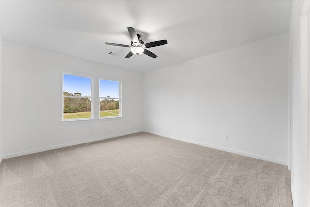 carpeted empty room featuring ceiling fan