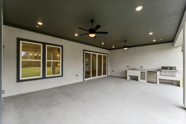 view of patio / terrace featuring ceiling fan, an outdoor kitchen, and a grill