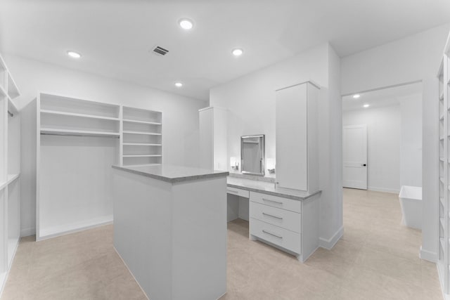 walk in closet featuring built in desk