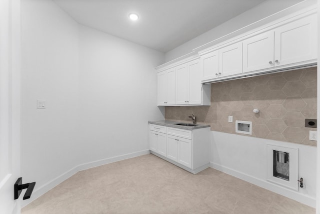 clothes washing area featuring cabinets, electric dryer hookup, sink, and washer hookup