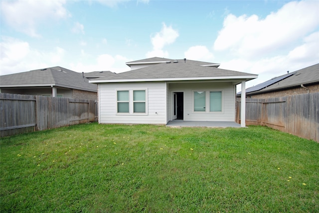 rear view of house with a patio area and a lawn