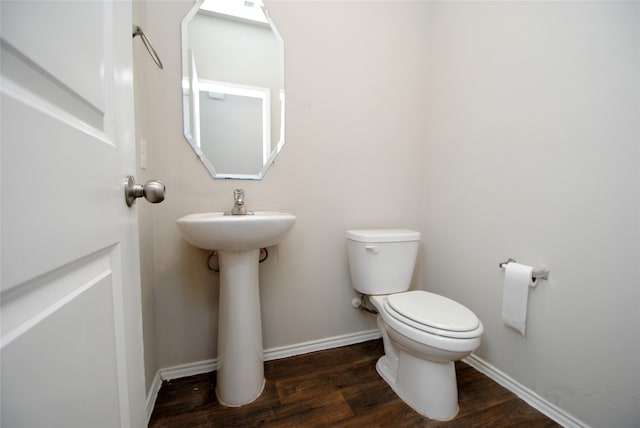 bathroom with wood-type flooring and toilet