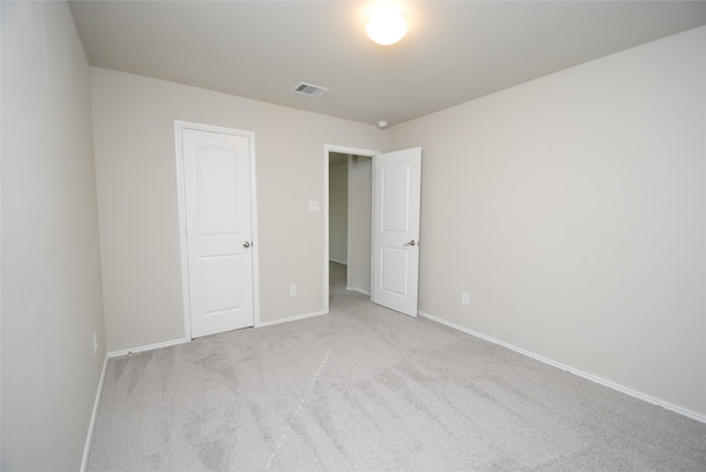 unfurnished room featuring light colored carpet