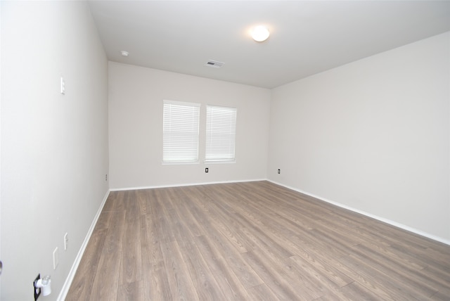 empty room with hardwood / wood-style floors