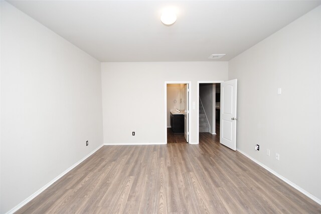 unfurnished room featuring wood-type flooring