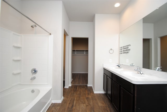 bathroom featuring bathing tub / shower combination, vanity, and wood-type flooring