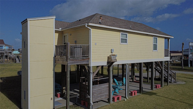 rear view of house with a yard and a balcony